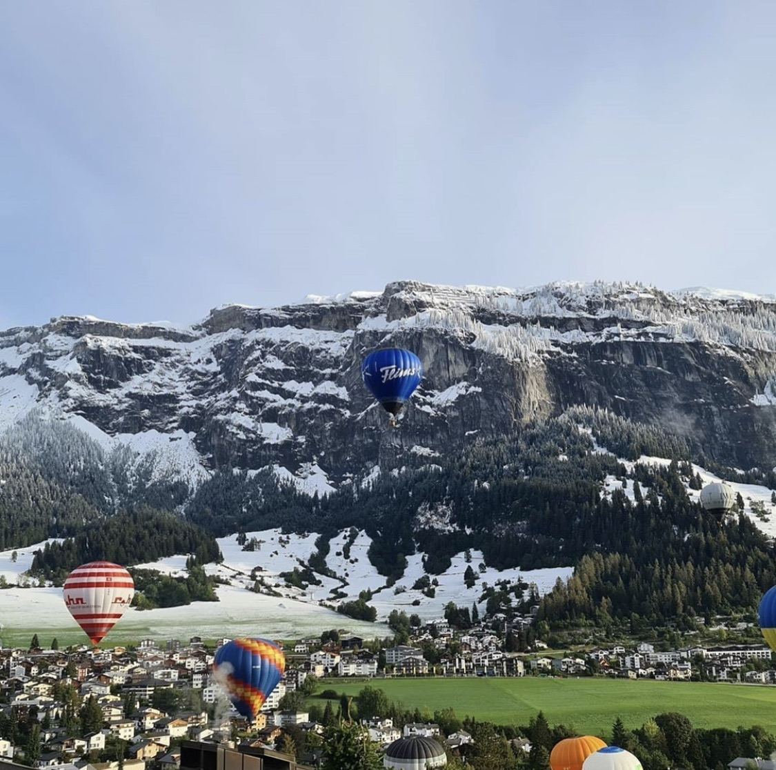 Hot-air balloons over Flims with mountain panorama